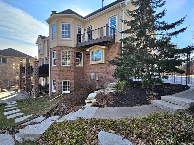 view of side of property featuring a balcony