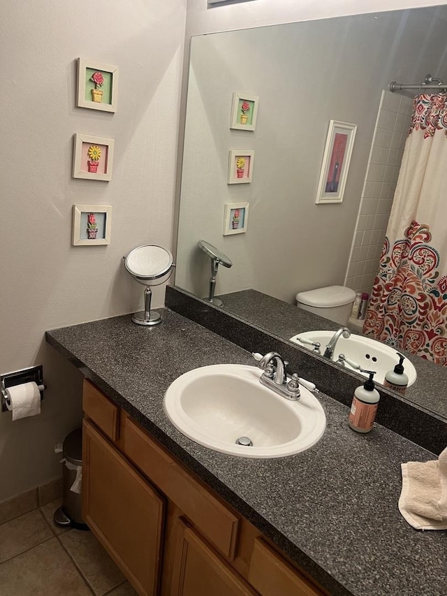 bathroom with vanity, curtained shower, tile patterned floors, and toilet