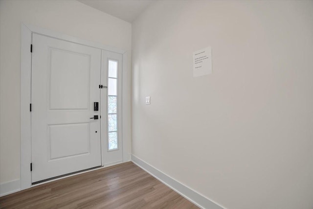 entrance foyer with baseboards and wood finished floors