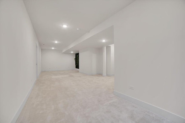 basement featuring light carpet