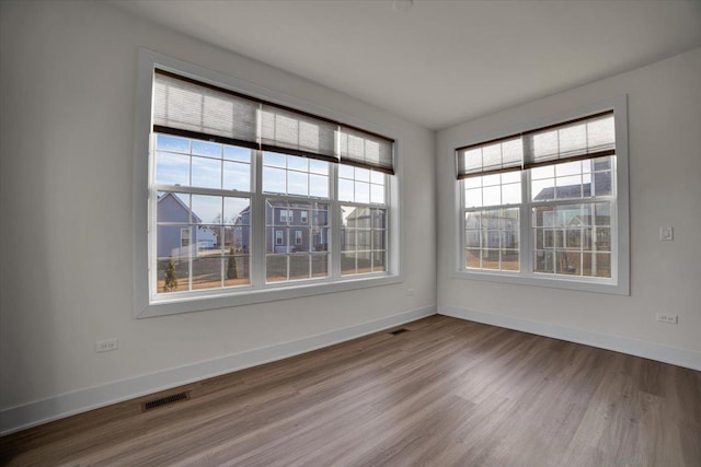 unfurnished room with hardwood / wood-style floors