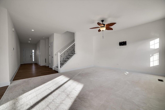 living room with dark carpet and ceiling fan