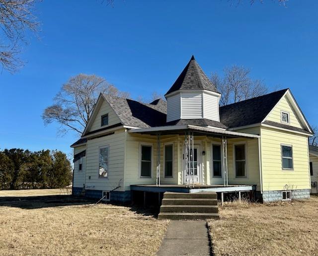 victorian-style house featuring a front yard and a porch