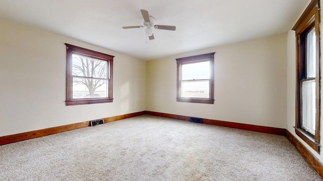 spare room featuring ceiling fan and carpet floors