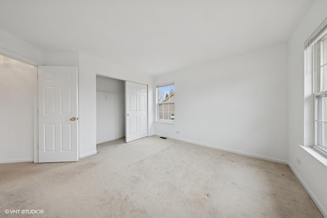 unfurnished bedroom with a closet, baseboards, and carpet floors