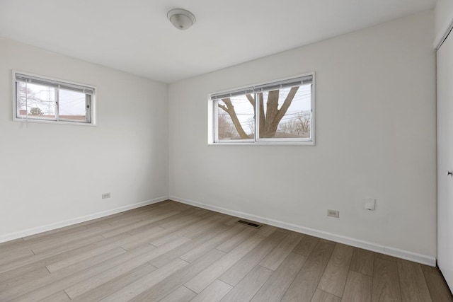 spare room featuring light hardwood / wood-style floors