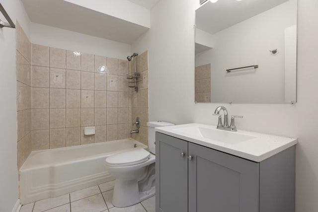 full bathroom featuring vanity, tile patterned floors, toilet, and tiled shower / bath