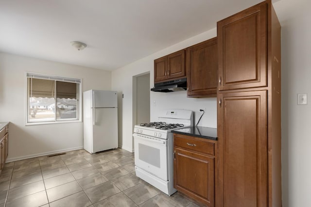 kitchen with light tile patterned floors and white appliances