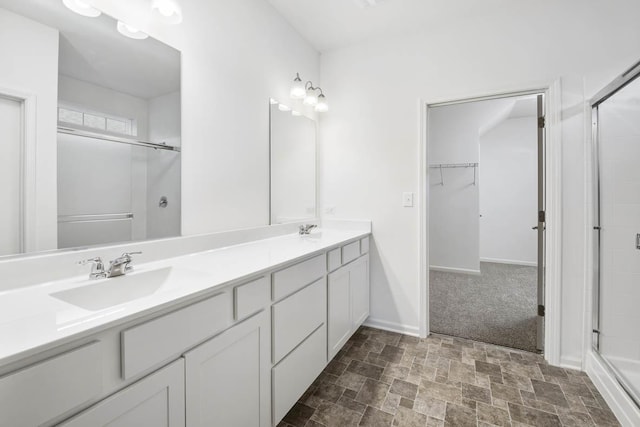 bathroom featuring vanity and a shower with door