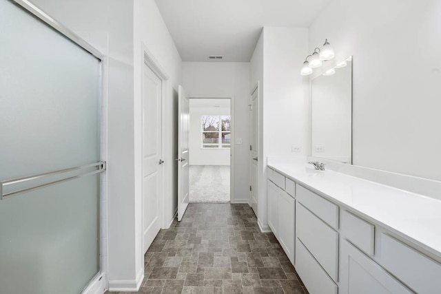 bathroom with vanity and walk in shower