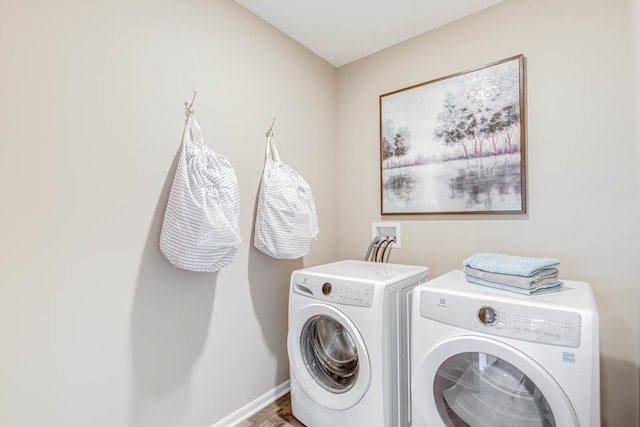 clothes washing area with washer and clothes dryer