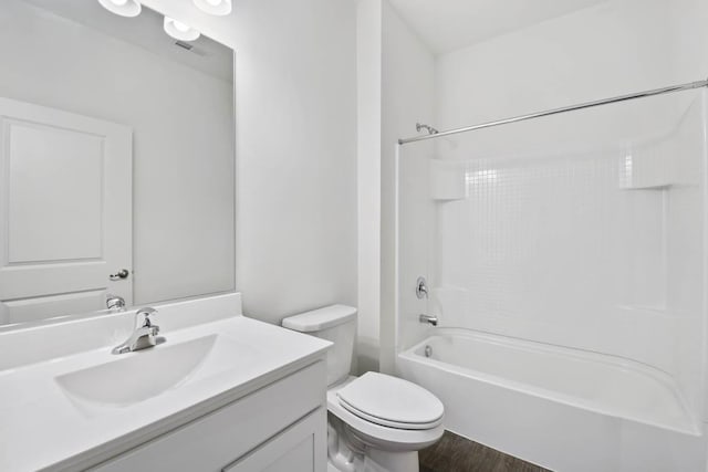 full bathroom featuring vanity, hardwood / wood-style floors, bathtub / shower combination, and toilet