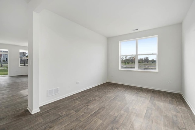 unfurnished room featuring dark wood-type flooring