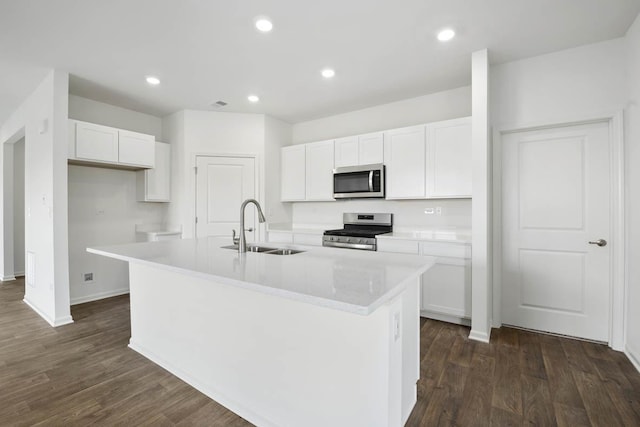 kitchen with a kitchen island with sink, sink, stainless steel appliances, and white cabinets