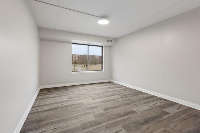 spare room featuring wood-type flooring