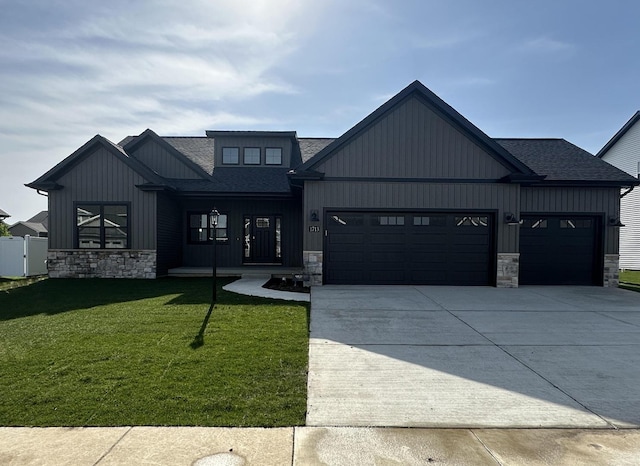 1713 Littlefield Ln, Mahomet, IL 61853 - modern farmhouse with a shingled roof, stone siding, a front lawn, and a garage