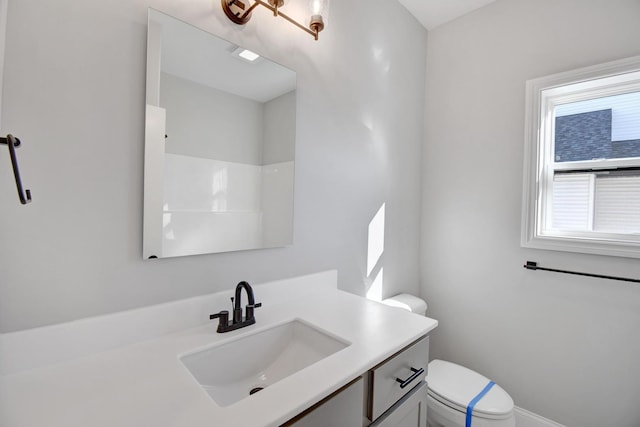 bathroom featuring vanity and toilet