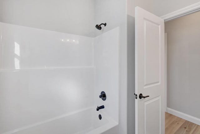 1713 Littlefield Ln, Mahomet, IL 61853 - bathroom featuring shower / tub combination, wood finished floors, and baseboards