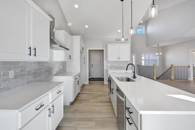 1713 Littlefield Ln, Mahomet, IL 61853 - kitchen with a sink, wall chimney range hood, stainless steel dishwasher, high vaulted ceiling, and backsplash