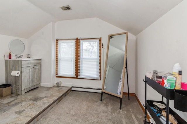 interior space with vaulted ceiling, a baseboard radiator, visible vents, and baseboards