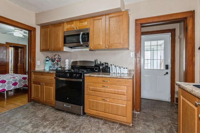 kitchen featuring appliances with stainless steel finishes and a ceiling fan