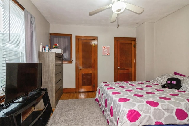 bedroom with light wood finished floors and a ceiling fan