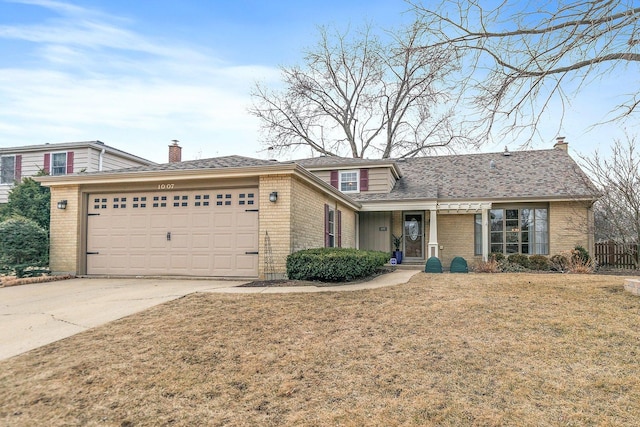 view of front of home featuring a garage and a front lawn