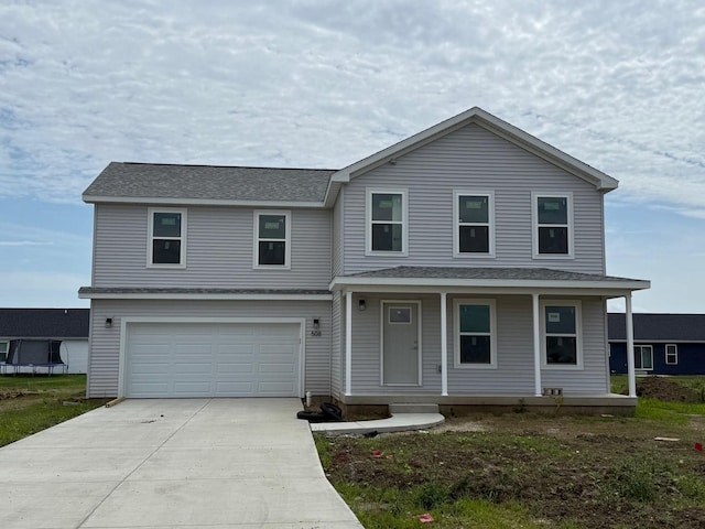 508 Patterson Dr, Fisher, IL 61843 - traditional-style home featuring a garage, covered porch, concrete driveway, and roof with shingles