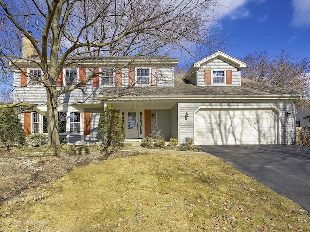 view of front facade featuring a garage, a porch, and aphalt driveway