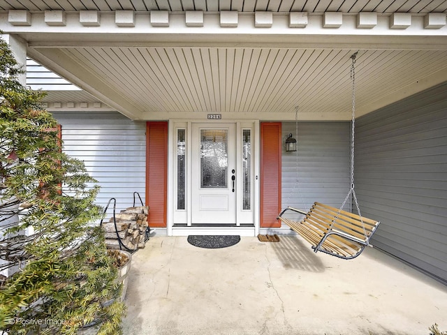 view of exterior entry featuring a porch