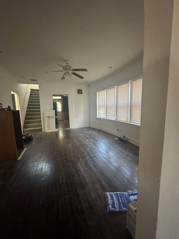 unfurnished living room featuring a wealth of natural light, ornamental molding, hardwood / wood-style floors, and ceiling fan