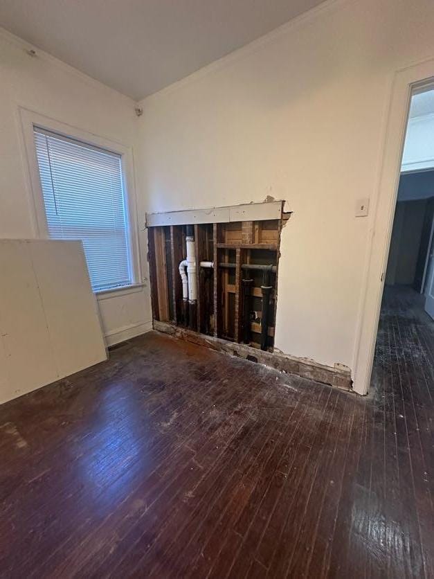 unfurnished living room with dark wood-type flooring