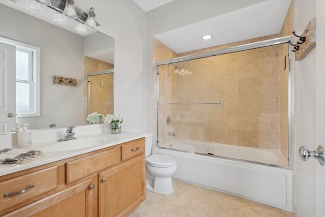 full bathroom with toilet, vanity, bath / shower combo with glass door, and tile patterned flooring