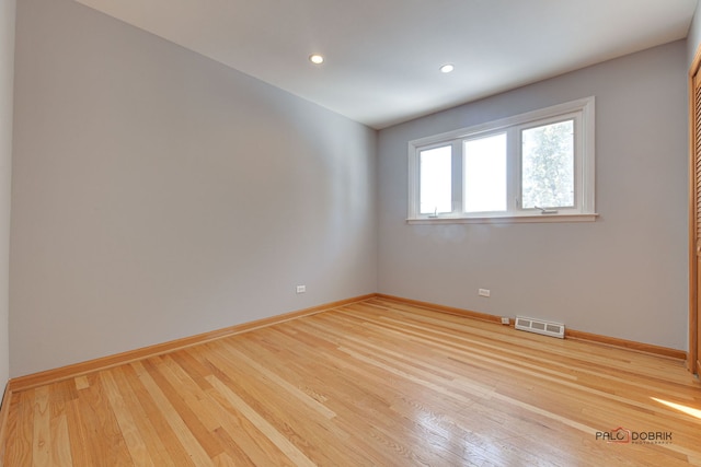 spare room with light hardwood / wood-style flooring