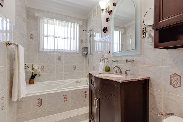 bathroom with tile walls, vanity, and tiled shower / bath combo