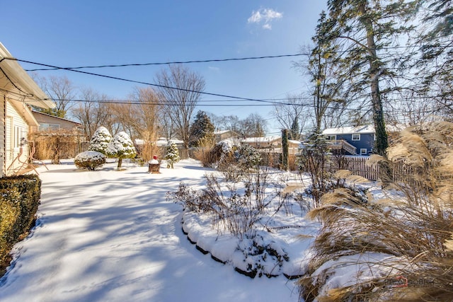 view of yard layered in snow