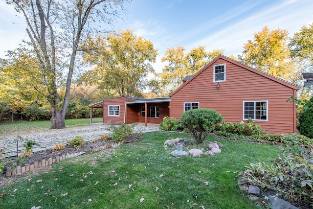 back of house featuring a yard