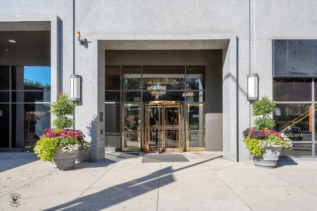 doorway to property featuring french doors and stucco siding