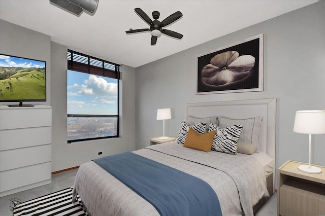 carpeted bedroom with a ceiling fan and baseboards