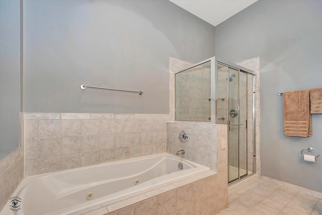 bathroom with a stall shower and a jetted tub