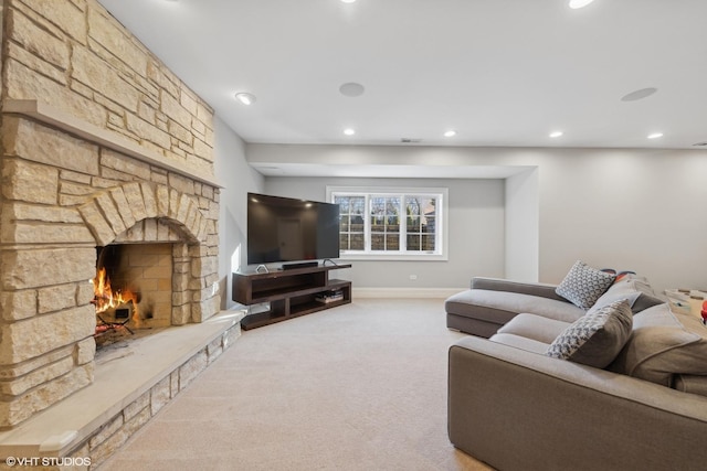 living room with carpet flooring and a stone fireplace