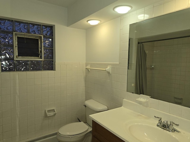 bathroom with tile walls, vanity, toilet, and walk in shower