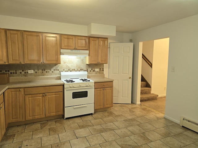 kitchen featuring decorative backsplash, a baseboard radiator, and white gas range