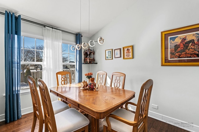 dining area featuring baseboards and dark wood-type flooring