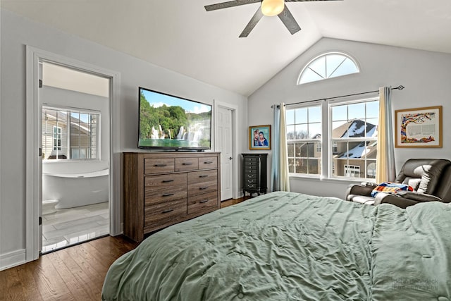 bedroom featuring dark wood-style floors, lofted ceiling, multiple windows, and connected bathroom