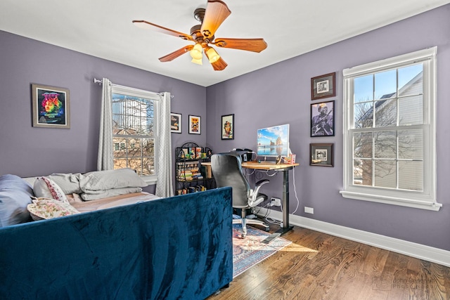 bedroom featuring ceiling fan, baseboards, and wood finished floors