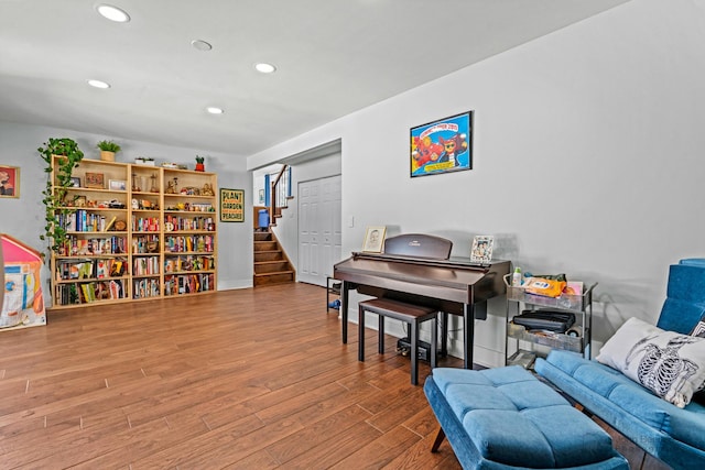 living area with stairs, recessed lighting, and wood finished floors