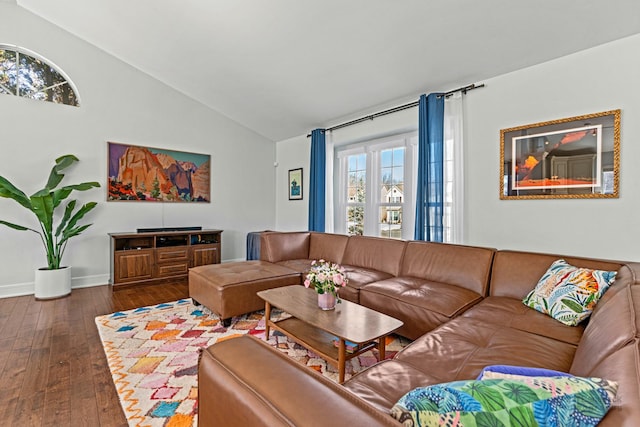 living area featuring vaulted ceiling, dark wood finished floors, and baseboards