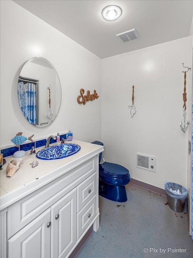 full bathroom featuring vanity, toilet, and visible vents