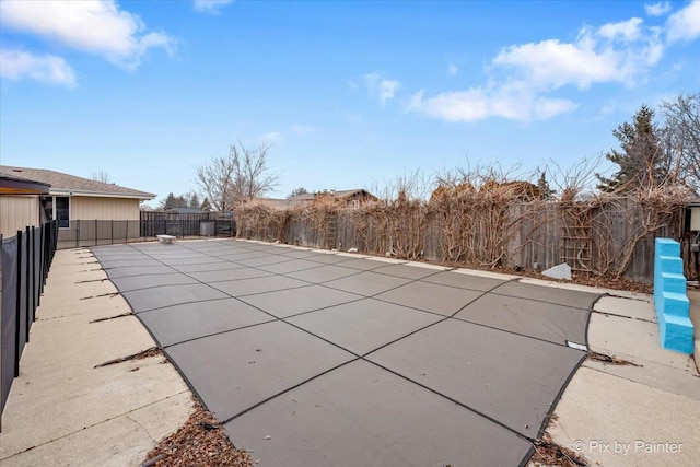 view of swimming pool featuring fence and a patio